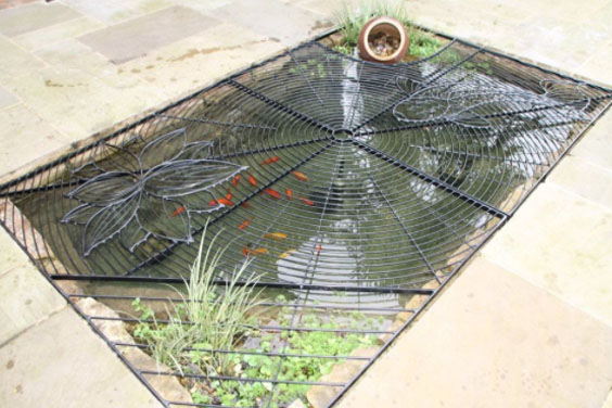 A koi pond with a mesh cover