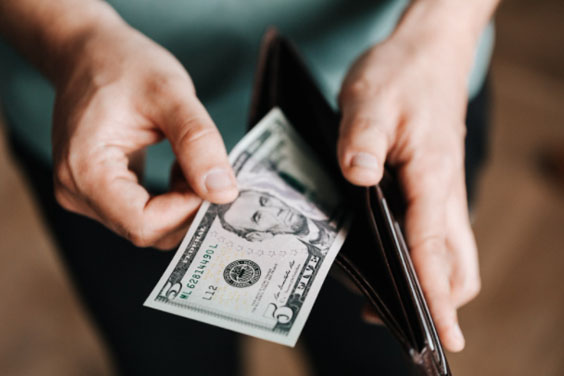 A person pulling money out of a wallet